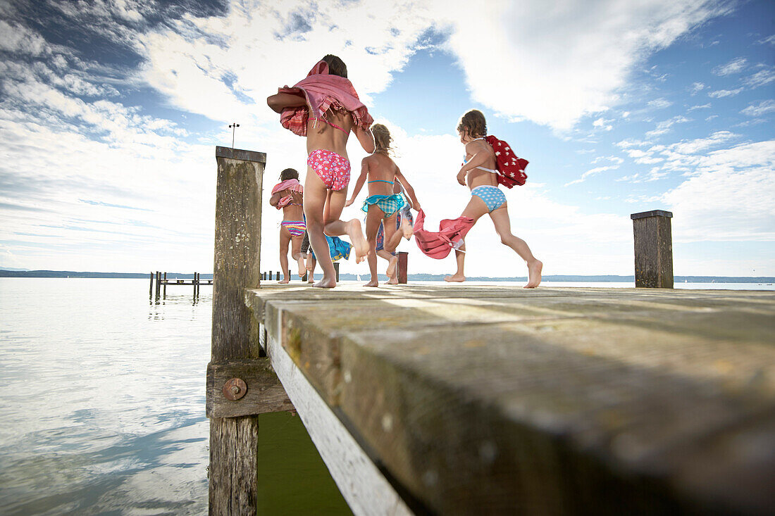 Children running along a jetty, lake Starnberg, Upper Bavaria, Bavaria, Germany