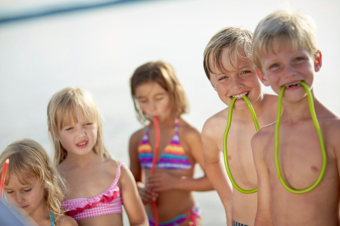 Children eating fruitgum sticks, lake Starnberg, Upper Bavaria, Bavaria, Germany