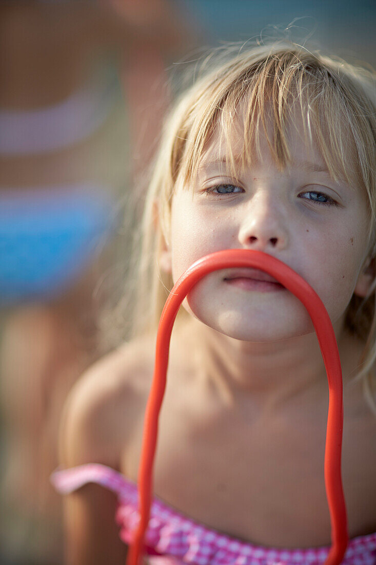 Girl with a fruitgum stick, lake Starnberg, Upper Bavaria, Bavaria, Germany