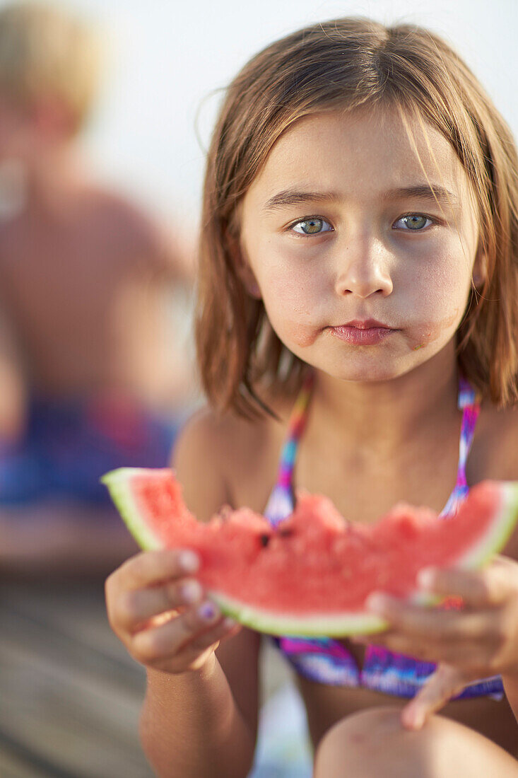 Girl holding a slice of melon, lake Starnberg, Upper Bavaria, Bavaria, Germany