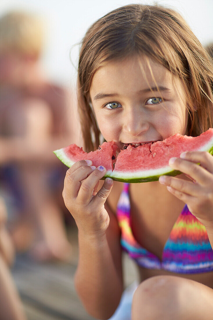 Girl eating a slice of melon, lake Starnberg, Upper Bavaria, Bavaria, Germany