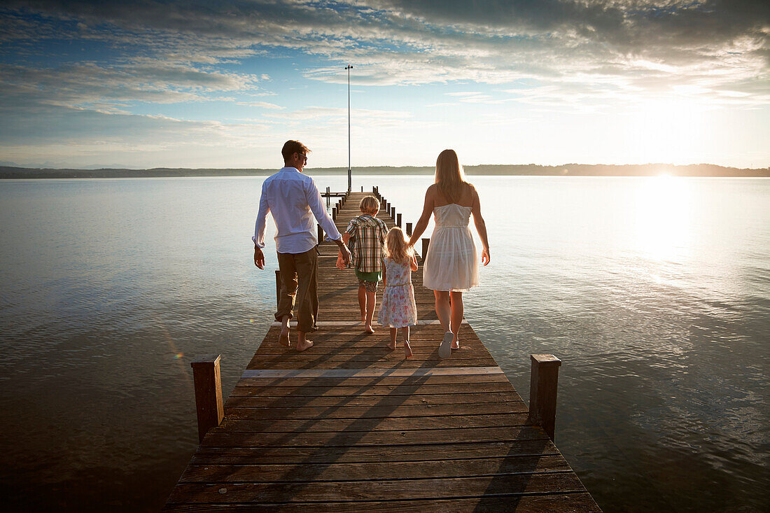 Family on a jetty at lake Starnberg, Upper Bavaria, Bavaria, Germany