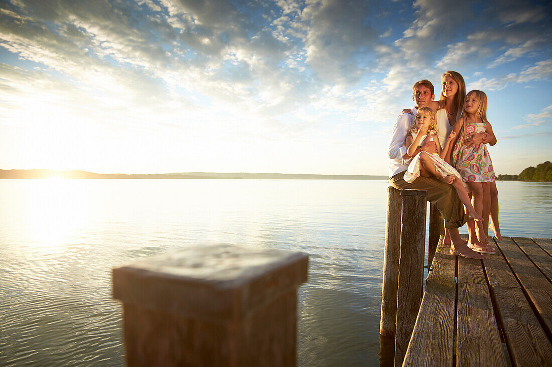 Family on a jetty at lake Starnberg, Upper Bavaria, Bavaria, Germany