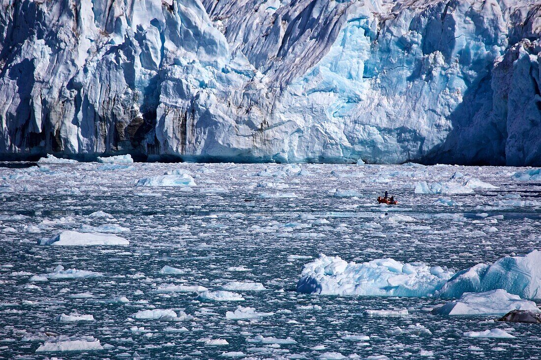 small boat in front of the icefall from the Knud Rasmussen Glacier, East Greenland, Greenland