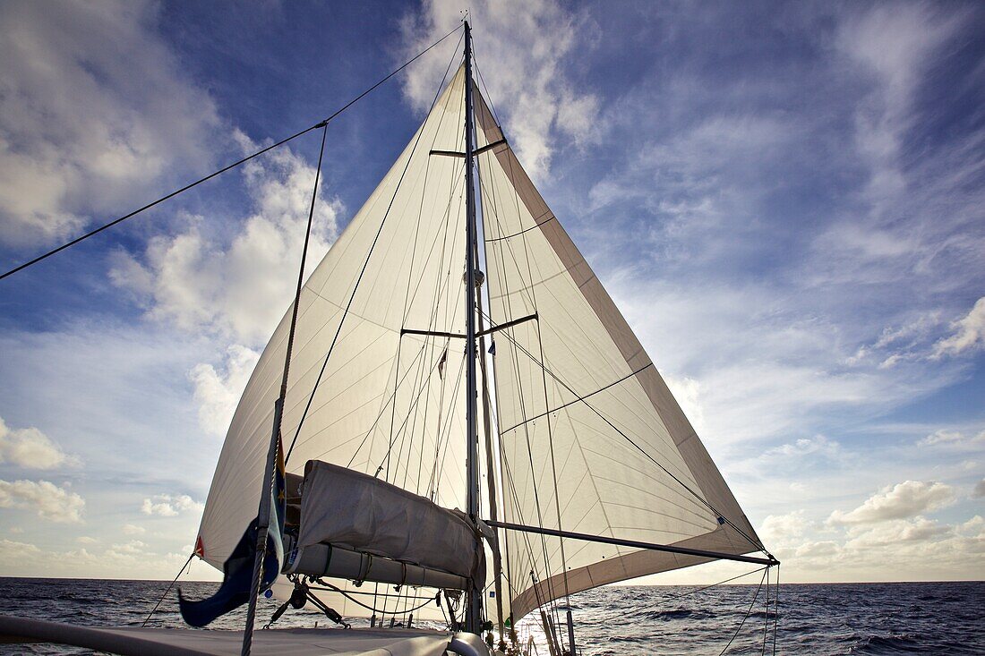 Sunset behind the sail of a sailing boat, yacht on the Atlantic ocean, Sailing