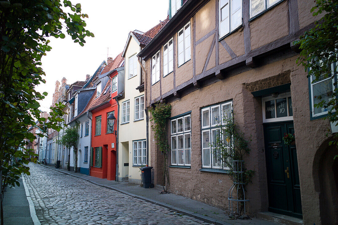 Street of cobblestones in historic city, Lubeck, Schleswig-Holstein, Germany