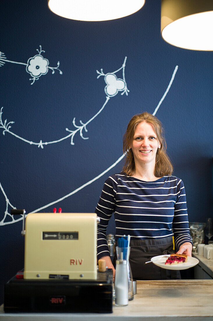 Portrait of woman working in a cafe, Lubeck, Schleswig-Holstein, Germany