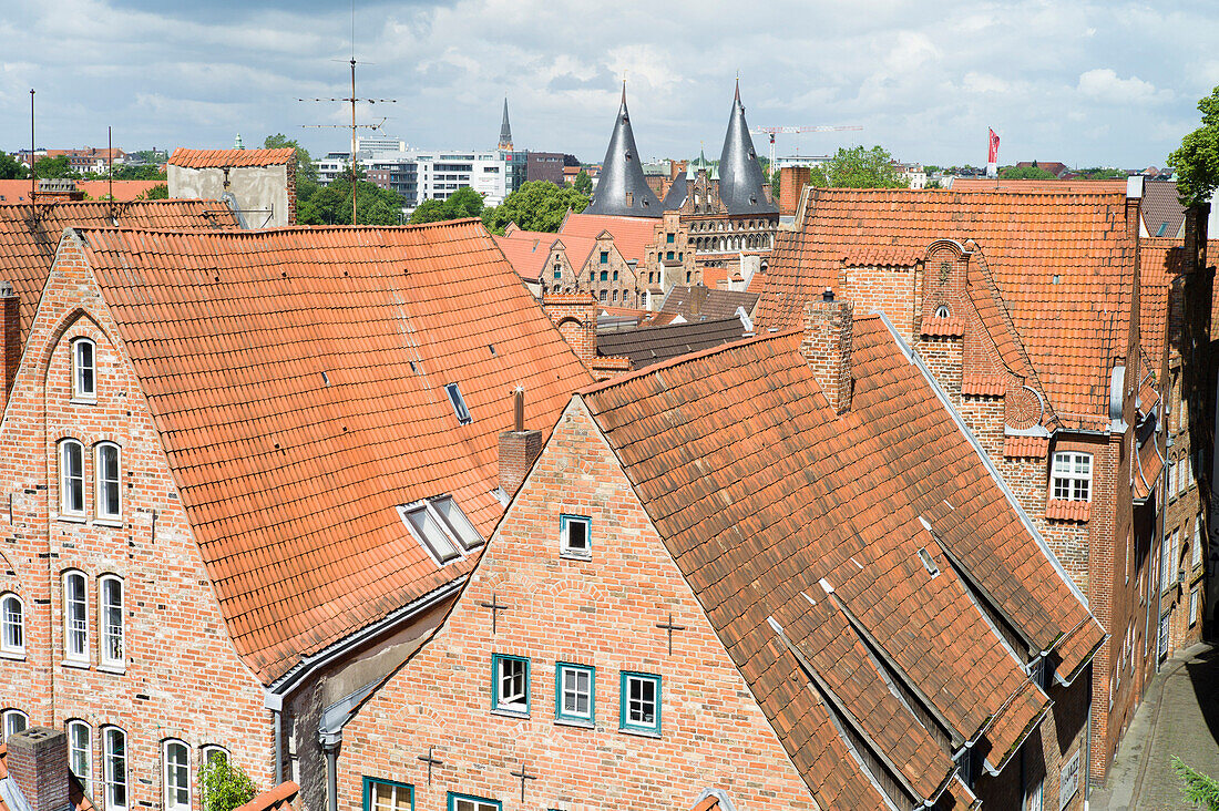 View over historic city with Holsten Gate in background, Lubeck, Schleswig-Holstein, Germany