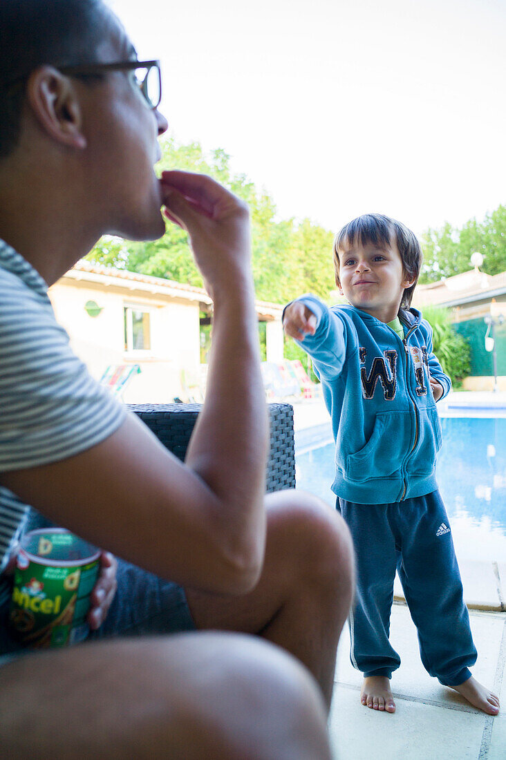 Smiling boy pointing to a man, Perols, Montpellier, Herault, Languedoc-Roussillon, France