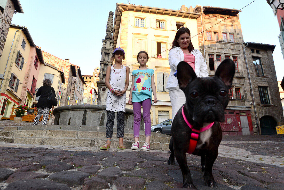 Family walking the dog in Le Puy en Velay, Allier, Auvergne, France