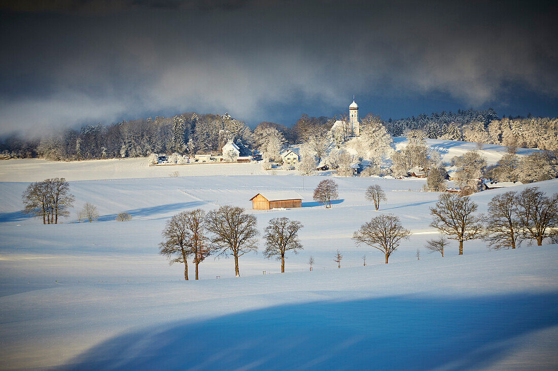 View to snow-covered Holzhausen, Munsing, Upper Bavaria, Germany