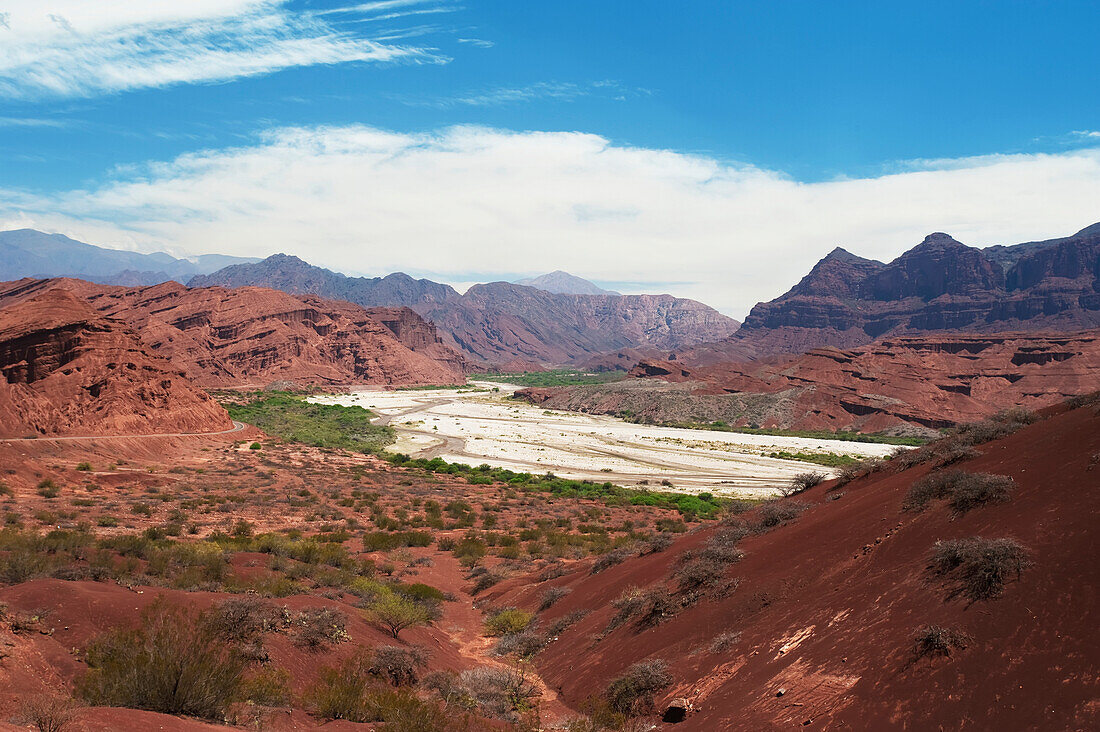 'Mountainous landscape with red soil and rock in a valley; Valle de Lerma, Salta Province, Argentina'