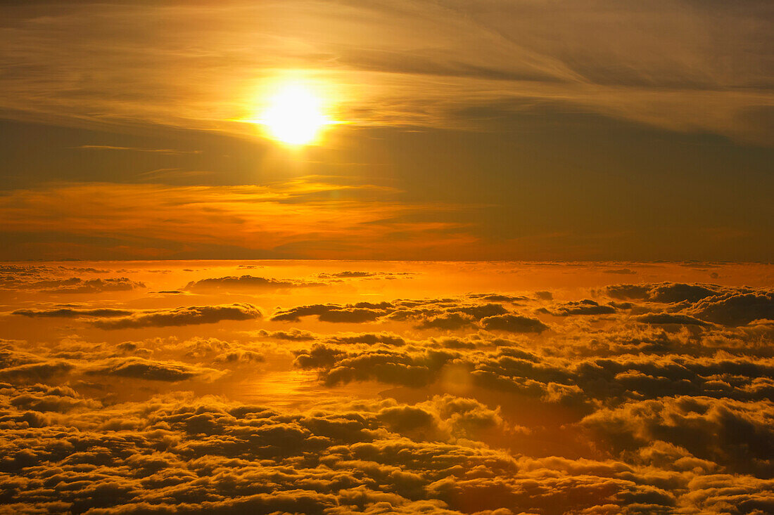 'Sunset viewed above the clouds at Haleakala National Park; Maui, Hawaii, United States of America'