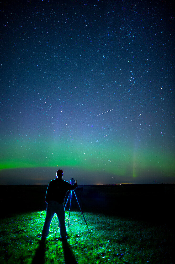 'A photographer captures the Northern lights and shooting star, near Edmonton; Alberta Canada'