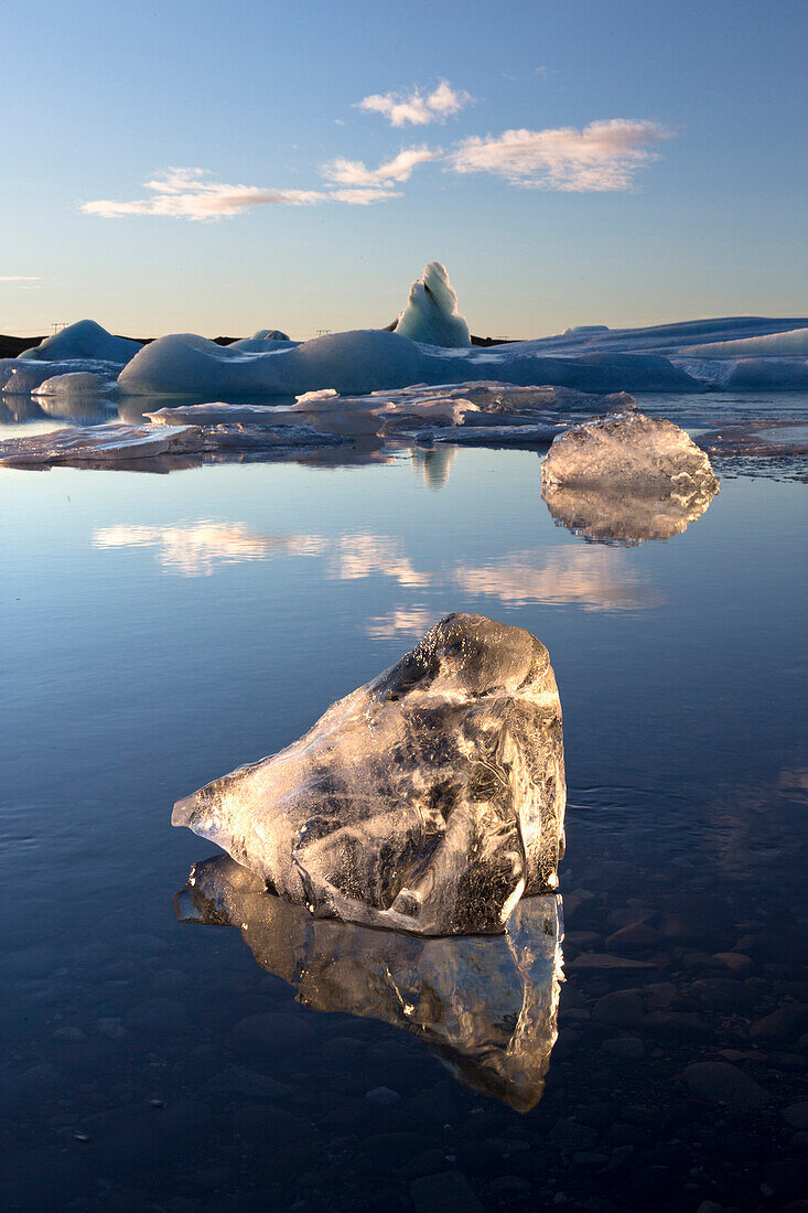 View of icebergs on Jokulsarlon, a glacial lagoon at the head of the Breidamerkurjokull Glacier, with some icebergs illuminated by the afternoon winter sun, on the edge of the Vatnajokull National Park, South Iceland, Iceland, Polar Regions