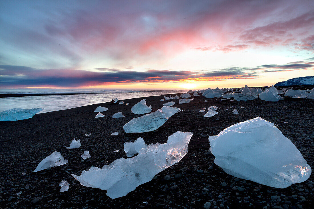 Icebergs at sunset on Jokulsa Beach, on the edge of the Vatnajokull National Park, South Iceland, Iceland, Polar Regions