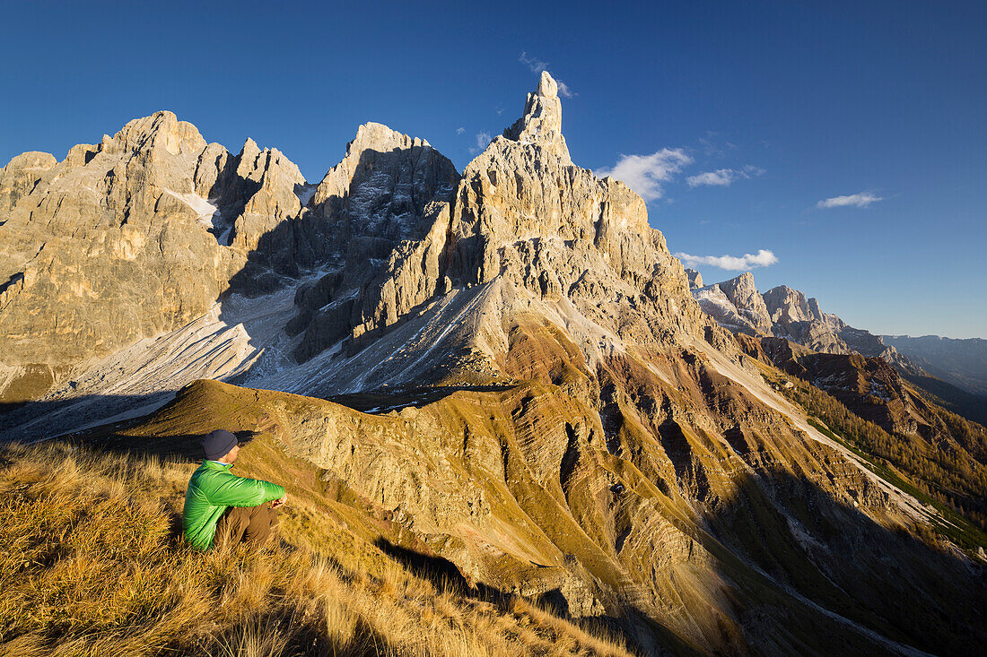 Hiker on the summit of a mountain, Bureloni (3130m), Vezzana (3192m), Cimon della Pala (3184m), Passo Rolle, Trentino, Alto Adige, Dolomites, Italy