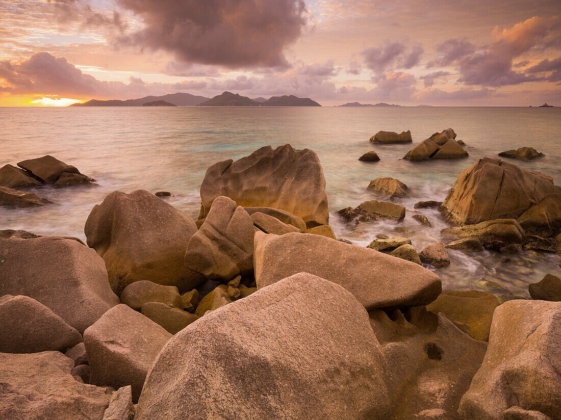 Rocky coastline at dusk, Anse Patates, La Digue Island, Seychelles