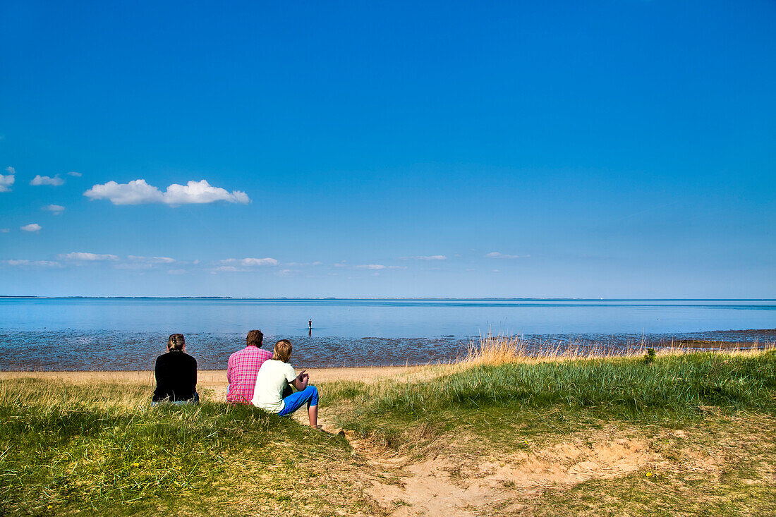 Family looking out to sea, Amrum Island, North Frisian Islands, Schleswig-Holstein, Germany
