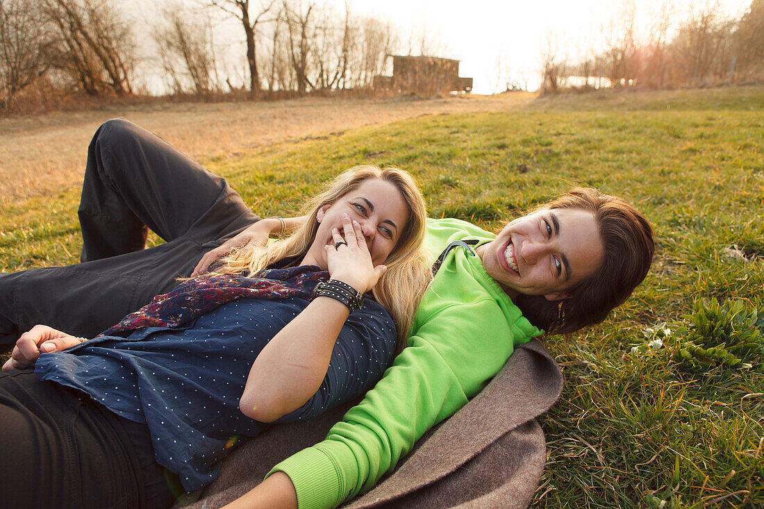 Young couple on a blanket, Grosser Alpsee, Immenstadt, Bavaria, Germany