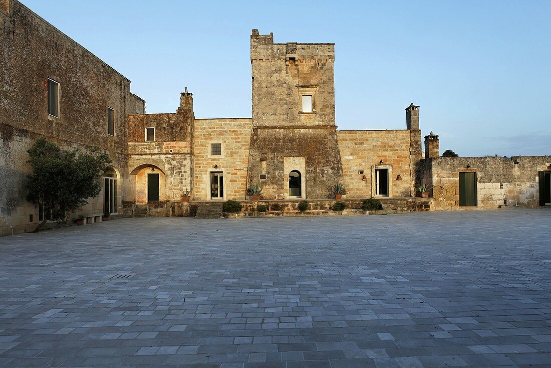 Large stone piazza in an Italian village with historic architecture
