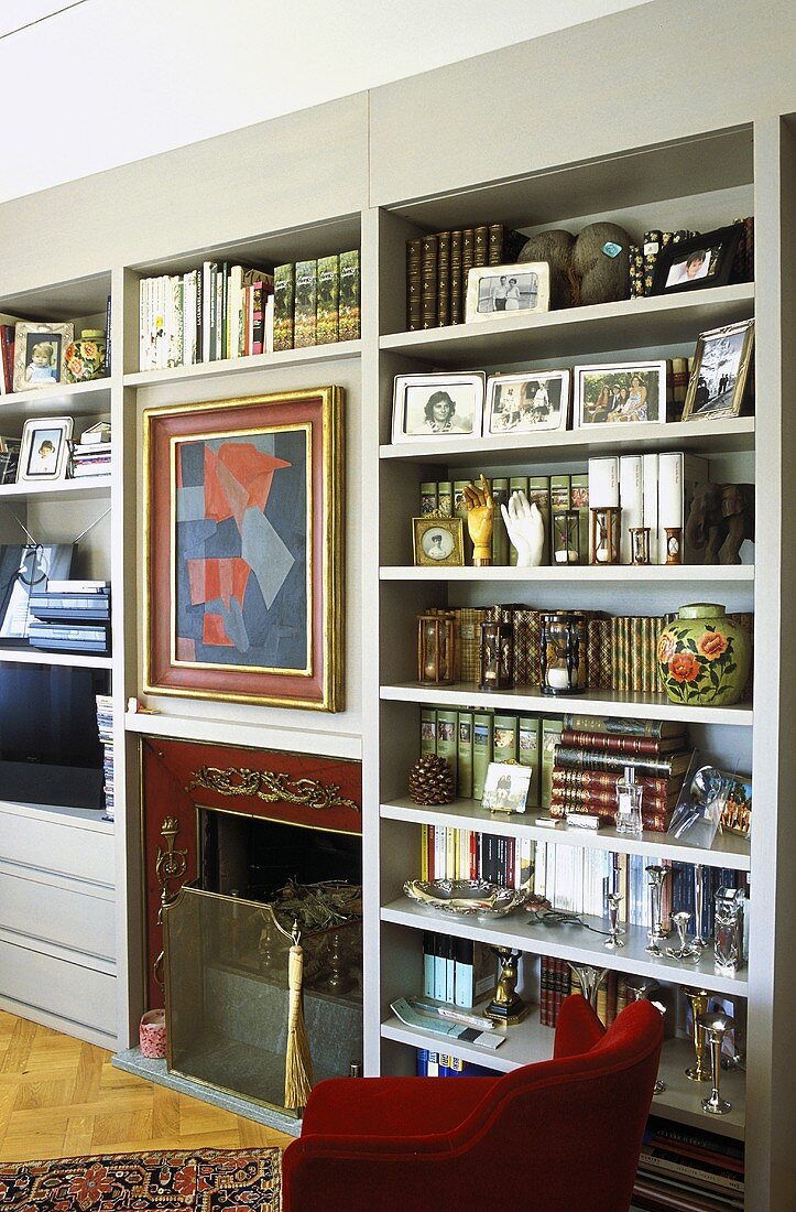 Gray built in book shelves with an integrated fireplace in a living room