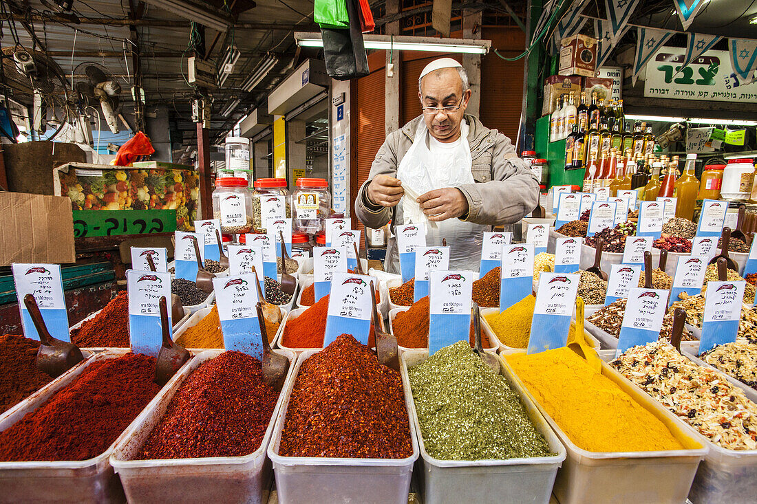 A vendor sells a large selection of Fresh ground spices in Tel Avivs Carmel Market.