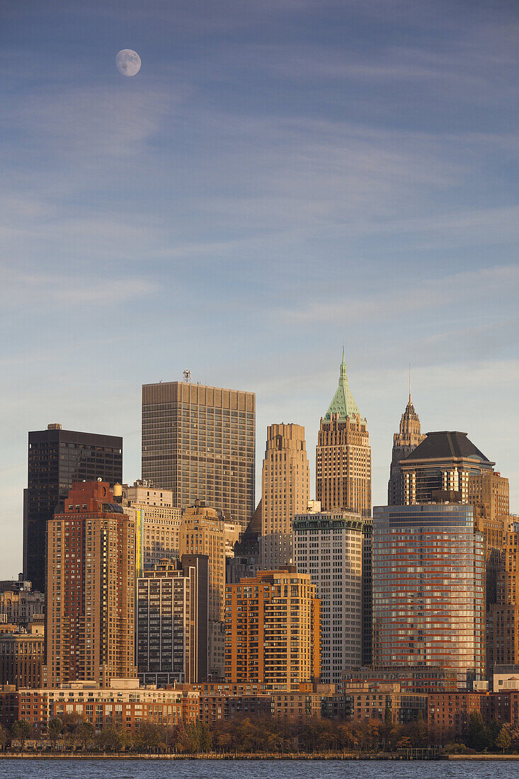 USA, New York, New York City, lower Manhattan skyline from Jersey City, late afternoon with moonrise.