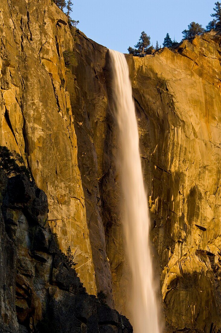 Sunset light on Bridalveil Fall waterfall, Yosemite Valley, Yosemite National Park, California