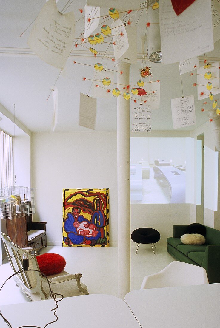 Living room with white supports and assorted seating