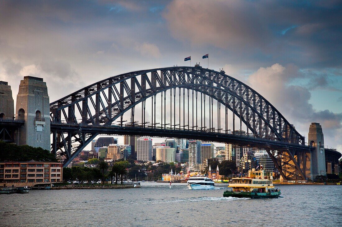 Ferry departs Circular Quay, Sydney harbour bridge at dawn, Sydney, NSW, Australia