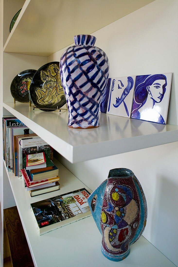 Painted vases on white shelves