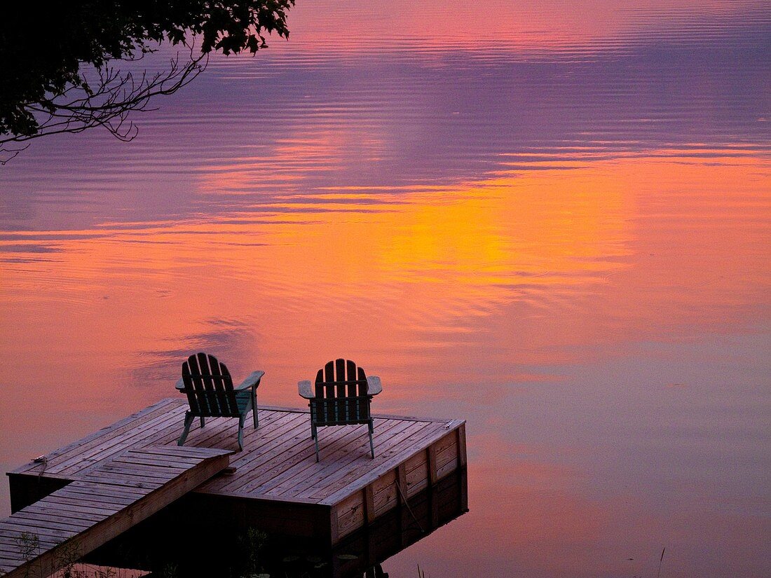 adirondack chairs lakeside on dock