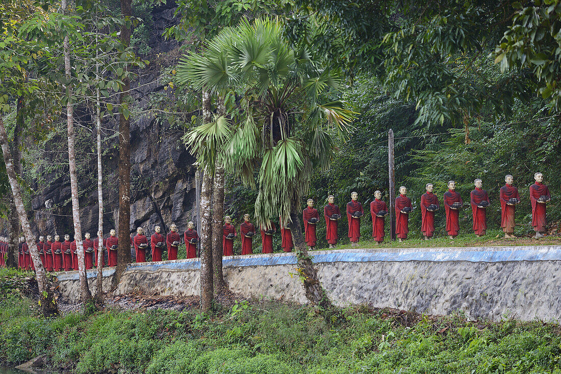 Myanmar, Kayin (Karen) State, Hpa-An surroundings, Monk statues line near Kaw Ka Thawng caves.