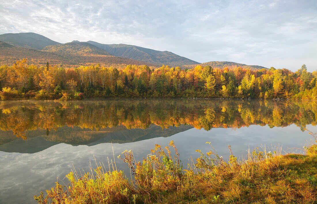 Northern Presidential Range from Durand Lake in Randolph, New Hampshire USA during the autumn months.