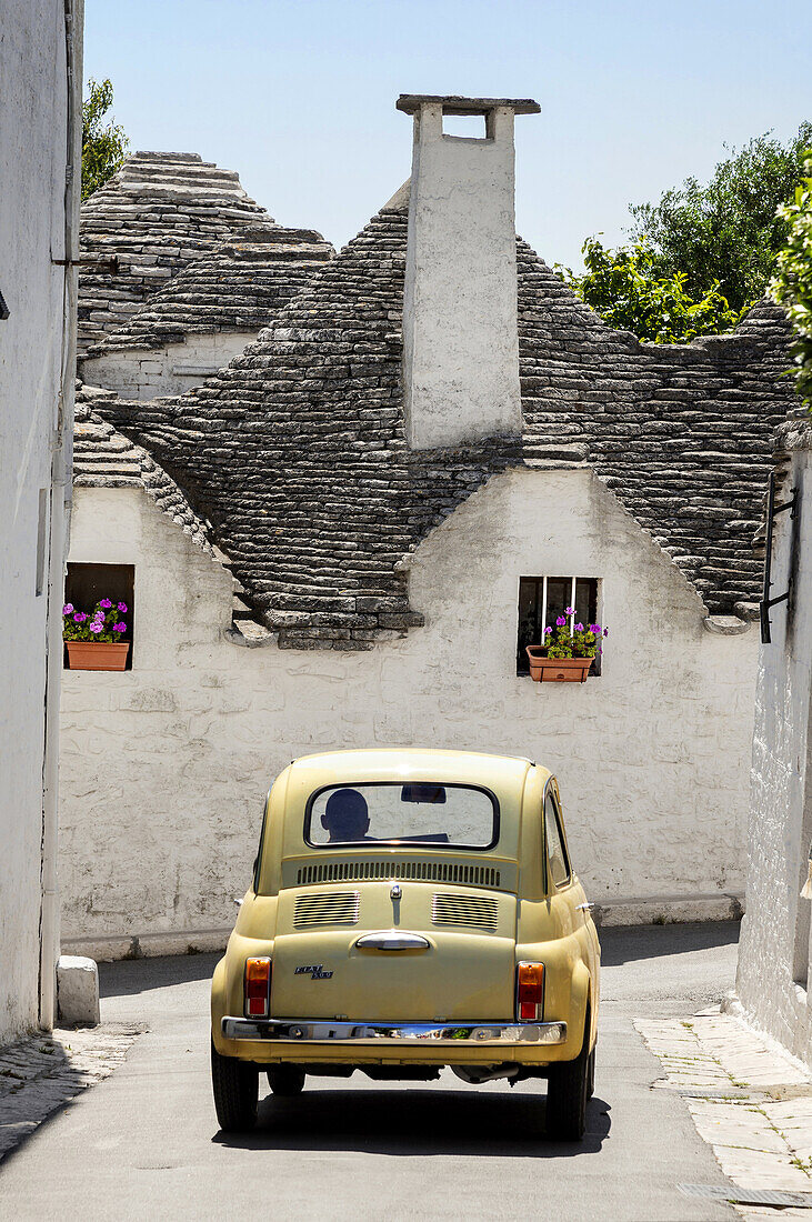 Fiat 500 and trulli houses at Alberobello, Puglia, Italy.