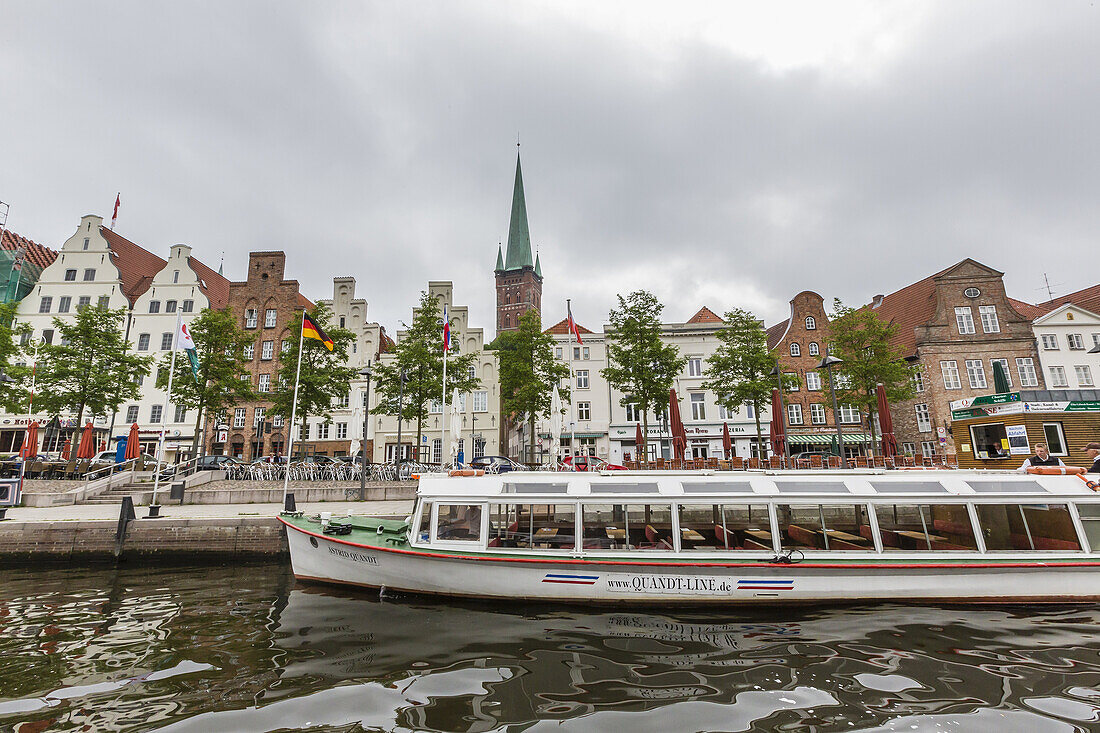 Canal tour boat on the River Trave at Travemünde in the medieval city of Lübeck, Germany.