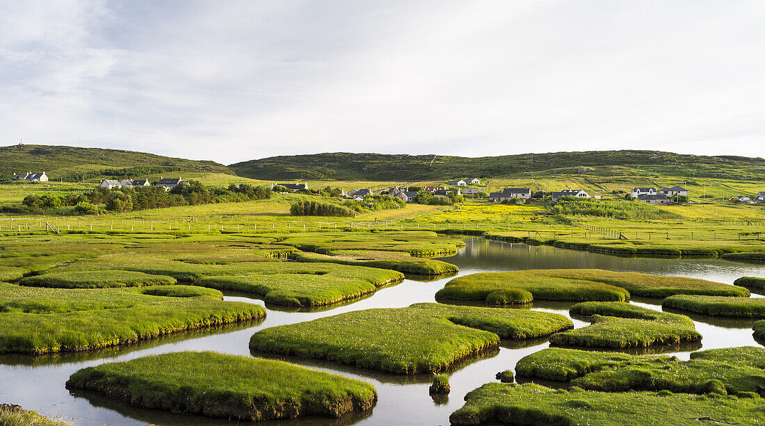Isle of Harris, part of the island Lewis and Harris in the Outer Hebrides of Scotland. The coastal salt marsh near Northton during sunset. Europe, Scotland, July.
