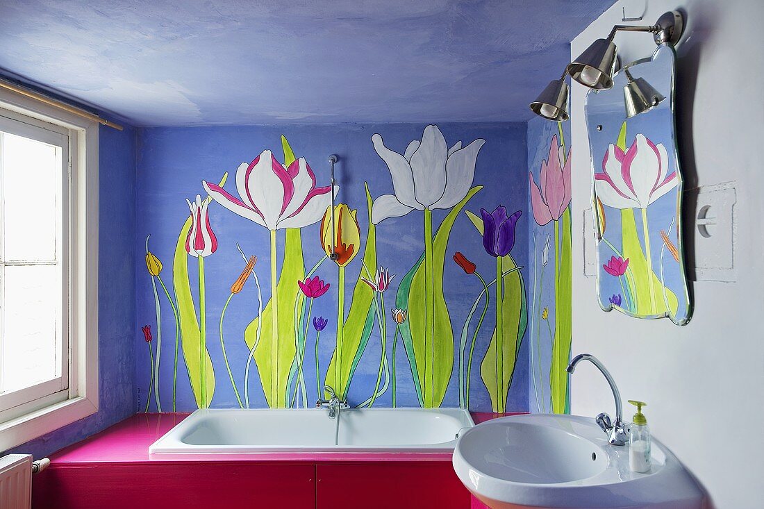 A bathroom with flowers on a blue wall