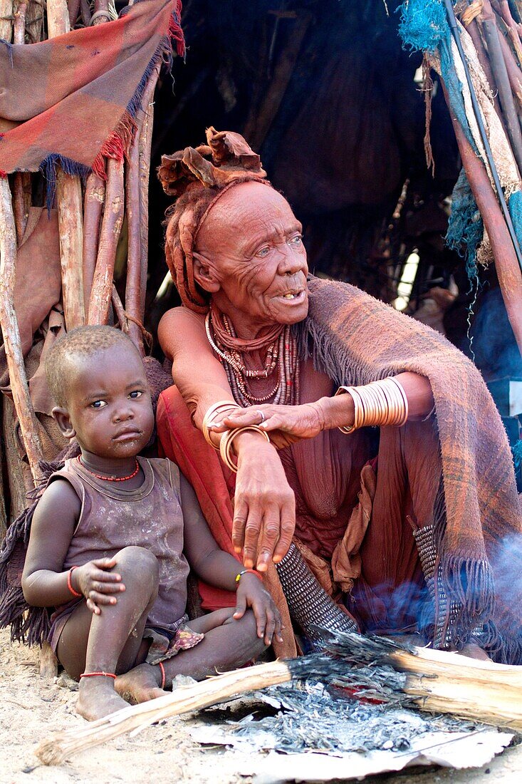 Himba woman with her grandson, Kaokoland, Kunene region, Namibia