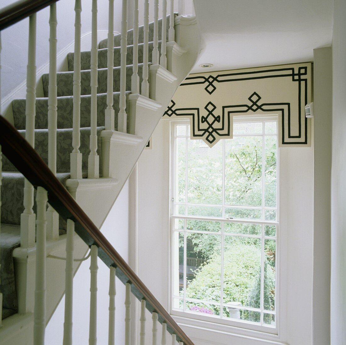A transom window with a pelmet in a stairway