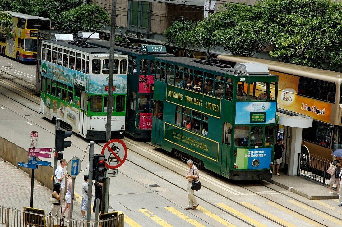 Double decker trams passing each other in the street, Hong Kong Island, Hong Kong, China.