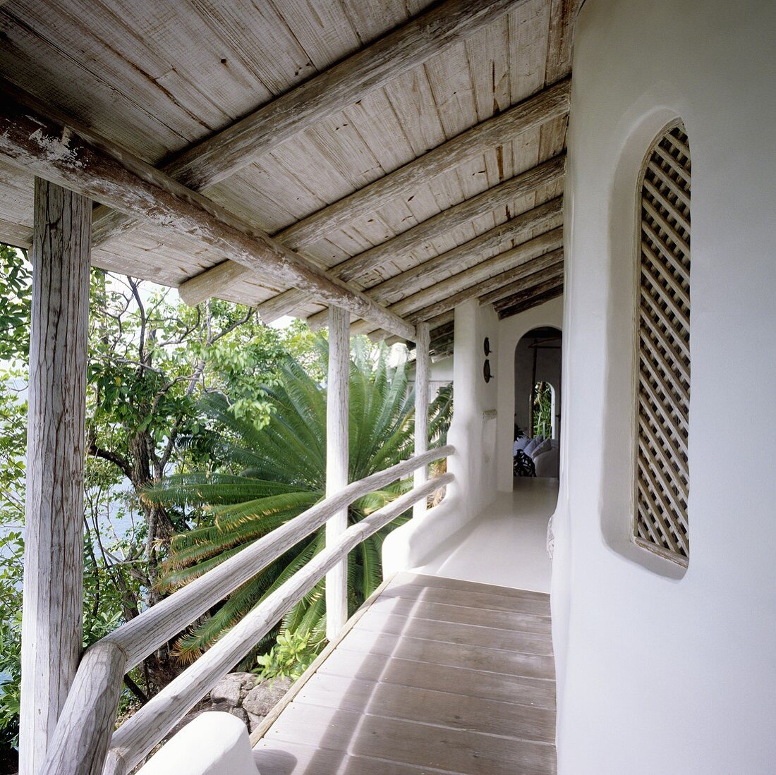 Bungalow with a balcony and rustic wooden roof with a view of the garden