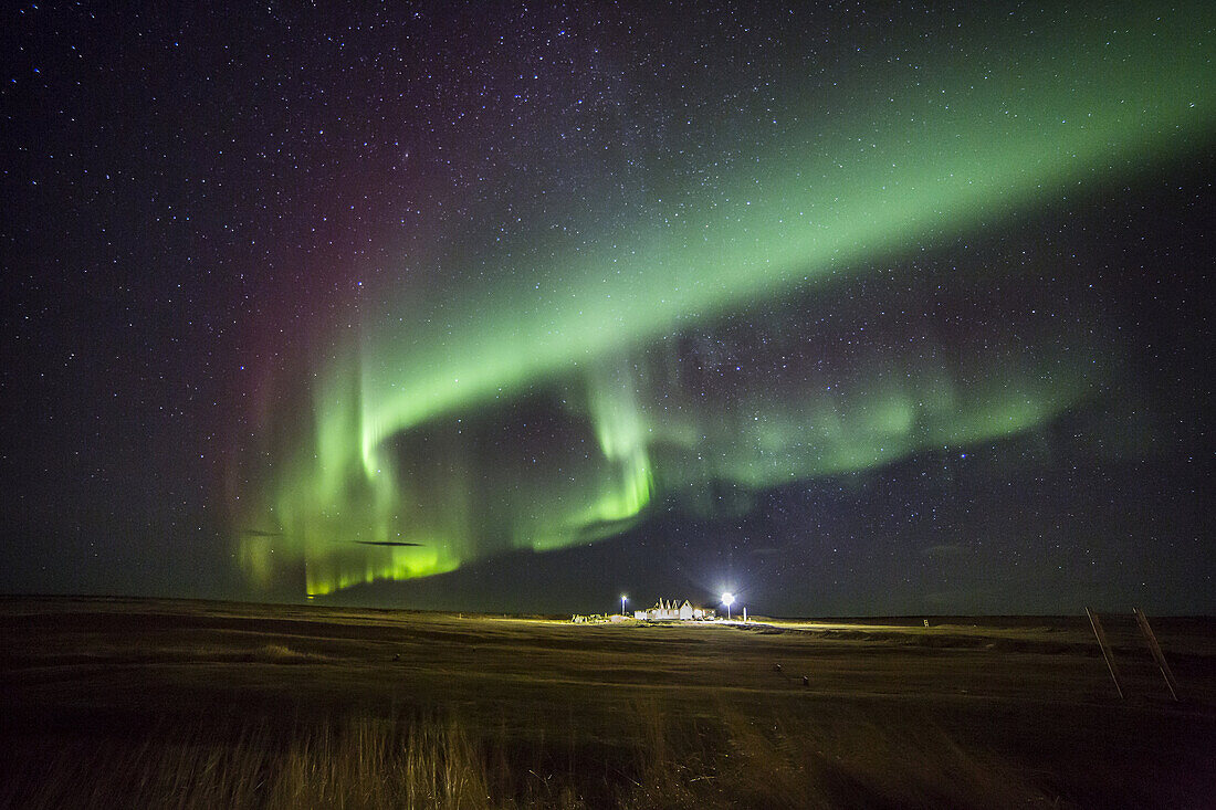 Aurora Borealis or Northern Lights by the town of Gardur, Reykjanes Peninsula, Iceland.