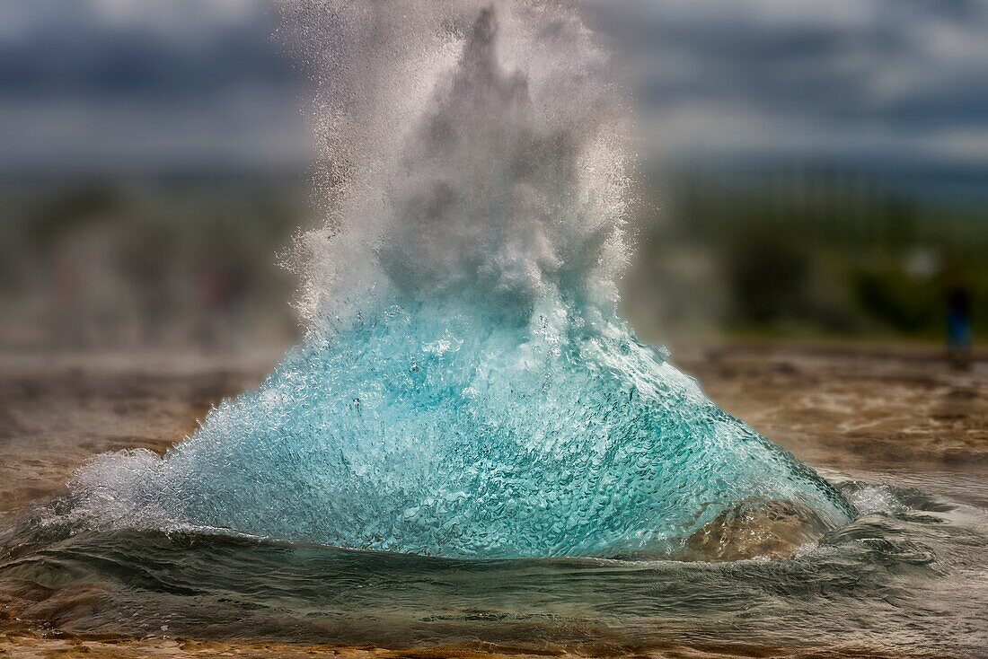 Strokkur Geyser just before it erupts, Iceland. Strokkur is a fountain geyser in the geothermal area beside the Hvita River in the Haukadalur valley, erupting about every 10 minutes or so. The white column of boiling water can reach as high as 20-30 meter