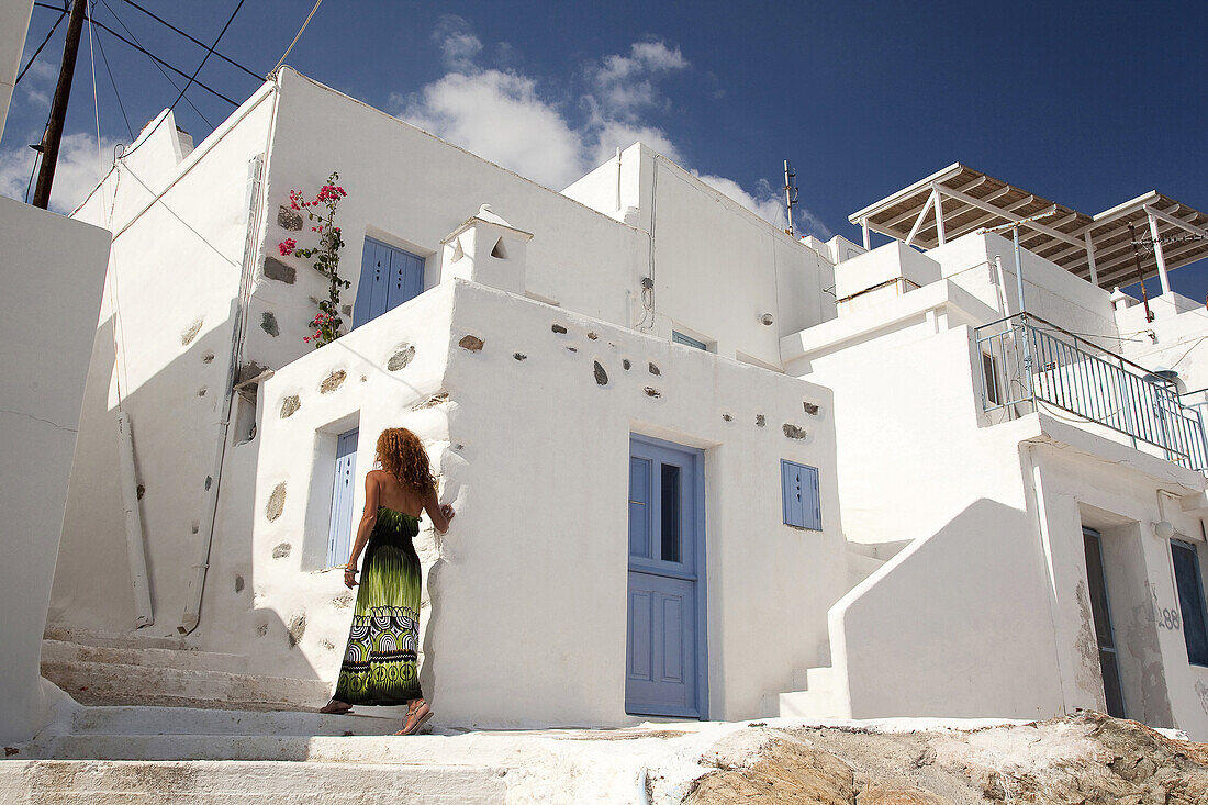 Woman in front of the houses in Hora, Serifos, Cyclades Islands, Greek Islands, Greece, Europe.