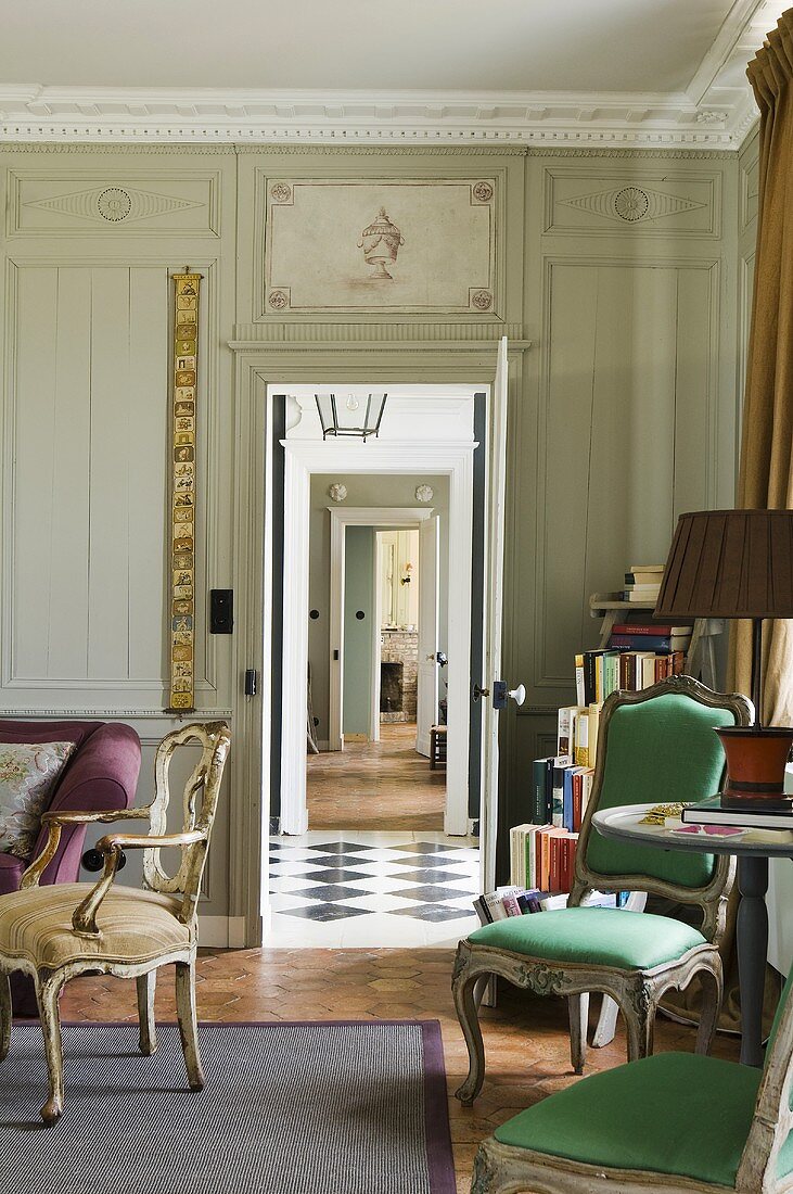 Baroque chairs in an anteroom with a view through an open door of a suite of rooms