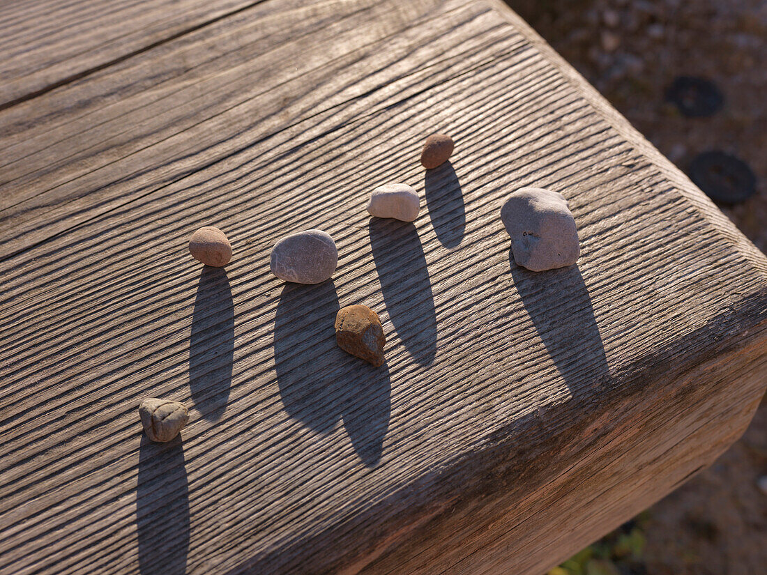 Pebbles on a wooden bench, Kallbrunn Alp, Lofer, Salzburger Land, Austria