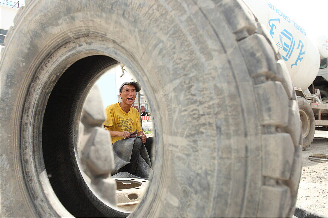 Worker behind a tire, tire repair shop, Ulaanbaatar, Mongolia