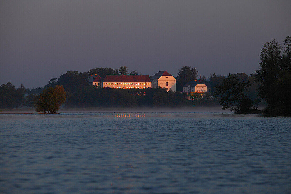 Old Castle and castle hotel Herrenchiemsee at sunrise, lake Chiemsee, Bavaria, Germany